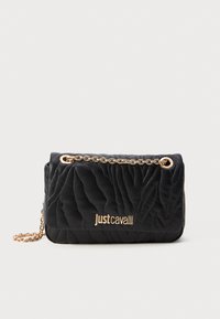 Black quilted handbag with gold chain strap and Just Cavalli logo in gold on front against white background.
