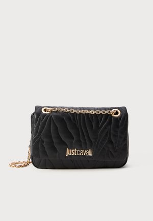 Black quilted handbag with gold chain strap and Just Cavalli logo in gold on front against white background.