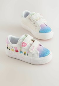 White sneakers with glittery blue and pink accents, featuring Peppa Pig designs and floral embroidery. Velcro straps for easy wear.