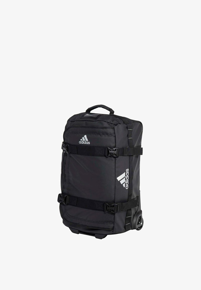 Sac de voyage à roulettes noir Adidas avec sangles à double boucle, poignée supérieure et logo Adidas visible à l'avant et sur le côté.