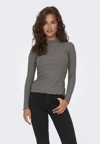 Gray ribbed long-sleeve top with a scalloped neckline and hem. Fitted design, made from a soft texture, paired with black fitted jeans.