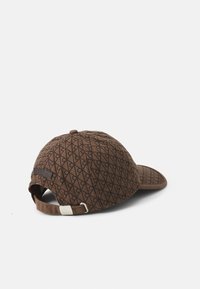 Brown baseball cap featuring a geometric pattern, structured shape, adjustable strap, and a textured fabric finish.