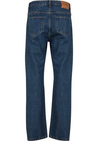 Dark blue denim jeans with a straight leg design, five pockets, and a leather patch on the back waistband. Distressed texture detail.