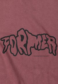 Maroon cotton t-shirt featuring black dripping text spelling "FORMER," with a small label underneath reading "The Colorless System of Control ©2017."