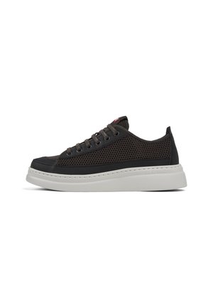 Black mesh sneaker with a white rubber sole, featuring round laces, reinforced toe, and contrasting stitching along the sole.