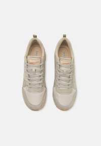 Light grey sneakers with mesh and suede materials, round toe, textured accents, and a rubber sole. Features laces and a pull tab.