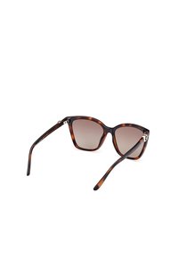 Ochelari de soare cu cadran din scoică cu lentile gri degradé, rame de formă pătrată și brațe negre elegante. Prezintă accente metalice pe balamale.