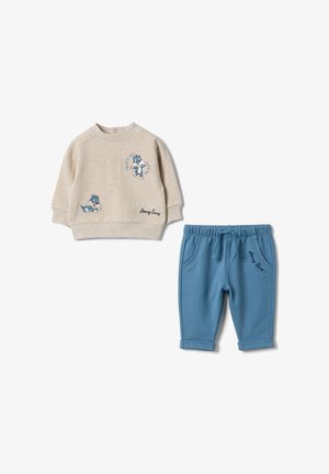 Felpa beige a maniche lunghe per bambini piccoli con gatto dei cartoni animati e pantaloni blu, entrambi con dettagli testuali "Looney Tunes".