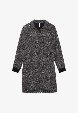 Zwart-wit bloemenpatroondraag met lange mouwen, een kraag en elastische zwarte manchetten. Bevat een gegolfde zoom.