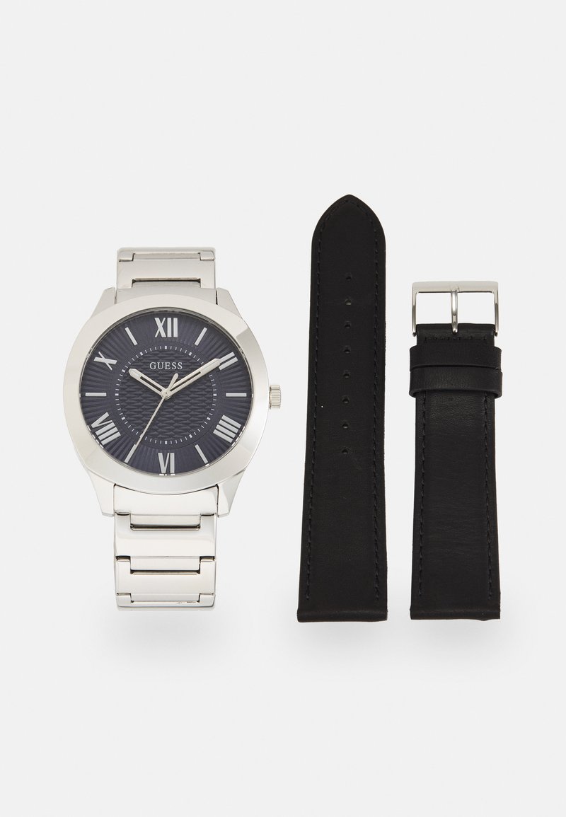 Silver metal watch with a dark blue patterned dial, silver Roman numerals, and a matching silver link bracelet; includes a black leather strap.
