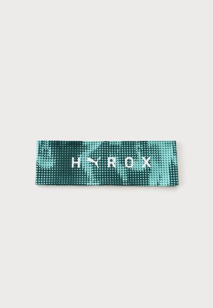 Elastisk modstandsbånd med sort og teal prikmønster, der viser det hvide Puma-logo og teksten "HYROX" i midten.