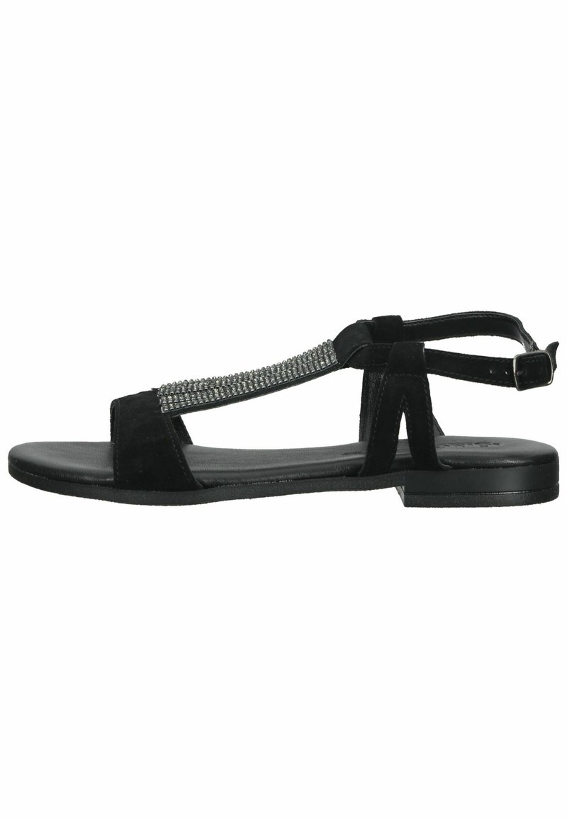Black suede sandals with a flat sole, T-strap design, and embellished rhinestone detail along the front strap. Adjustable ankle buckle.