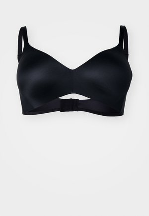 Black bra with smooth, molded cups and adjustable straps. Features a crossover design with a hook closure at the back.