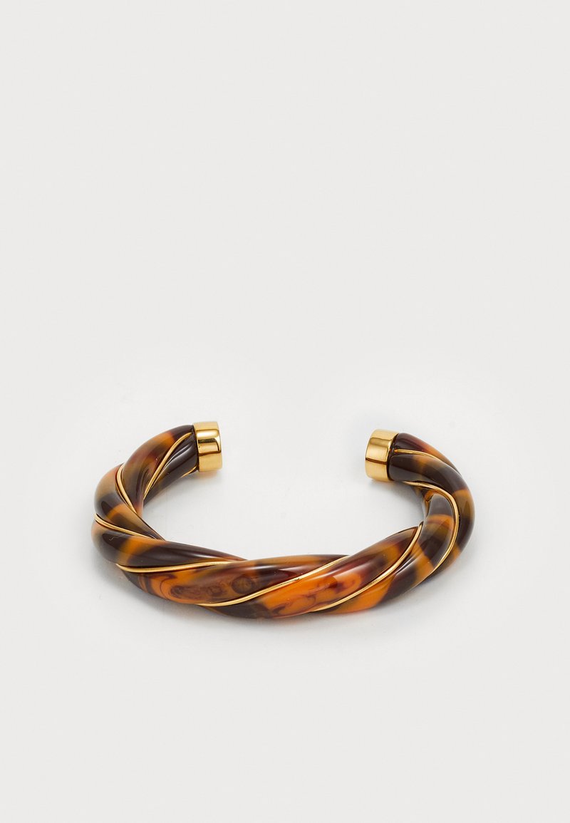Στριφτό βραχιόλι σε ακρυλικό χελώνας με χρυσές μεταλλικές λεπτομέρειες στις άκρες. Λείο υλικό με γυαλιστερή επιφάνεια.