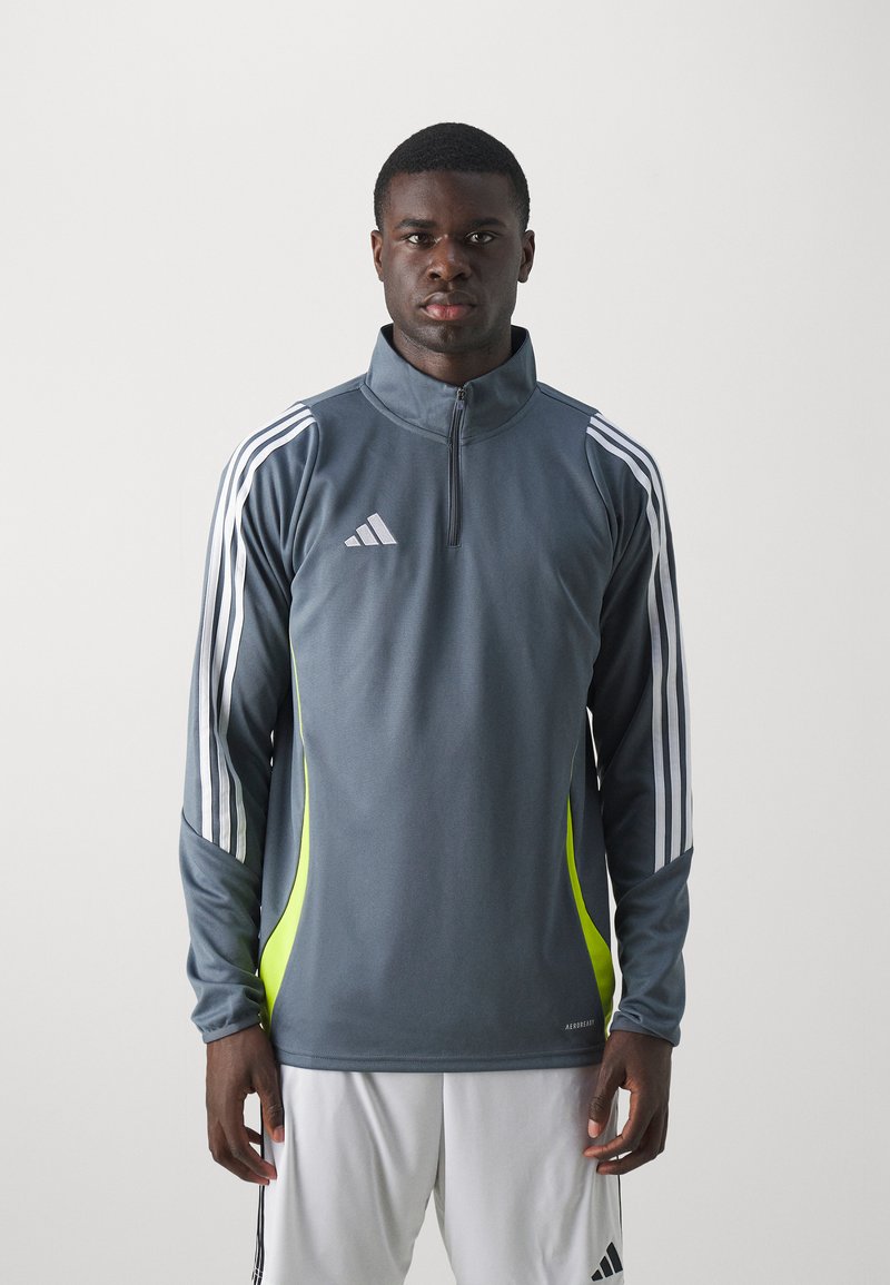 Gray athletic zip-up jacket with white stripes on sleeves, neon yellow side accents, and textured fabric. Features Adidas logo on chest.