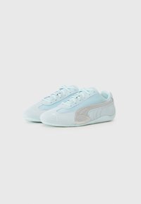 Light blue suede sneakers with mesh panels, flat laces, and a silver accent. Rounded toe and textured rubber sole for grip.