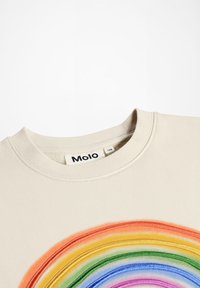 Beige mikina s okrúhlym výstrihom, s farebným vyšívaným dizajnom dúhy, vyrobená z mäkkého materiálu. Na štítku je nápis "Molo 128."