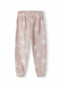 Pantalons en polaire rose avec un motif d'étoiles blanches, dotés d'une taille élastique et de jambes fuselées. Texture douce, design décontracté.