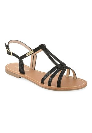 Sandale plate noire à bout ouvert, multiples fines lanières, boucle à la cheville, et semelle couleur beige, adaptée pour une tenue décontractée.