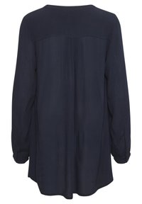 Dunkelbluse mit langen Ärmeln, Yoke-Rücken, lockerer Passform und geknöpften Manschetten.