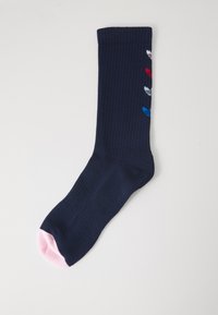 Navy ribbed sock with a pink toe. Features five small colored patterns in red, white, and blue along the side. Made from a soft textile.