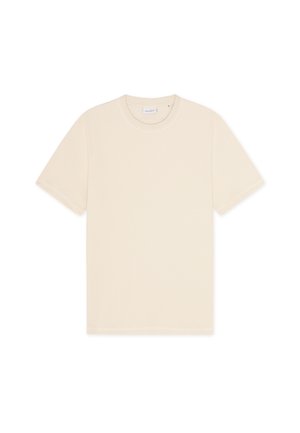 T-shirt in cotone di colore beige chiaro, con collo rotondo e maniche corte, caratterizzata da un design semplice e minimalista senza motivi visibili.