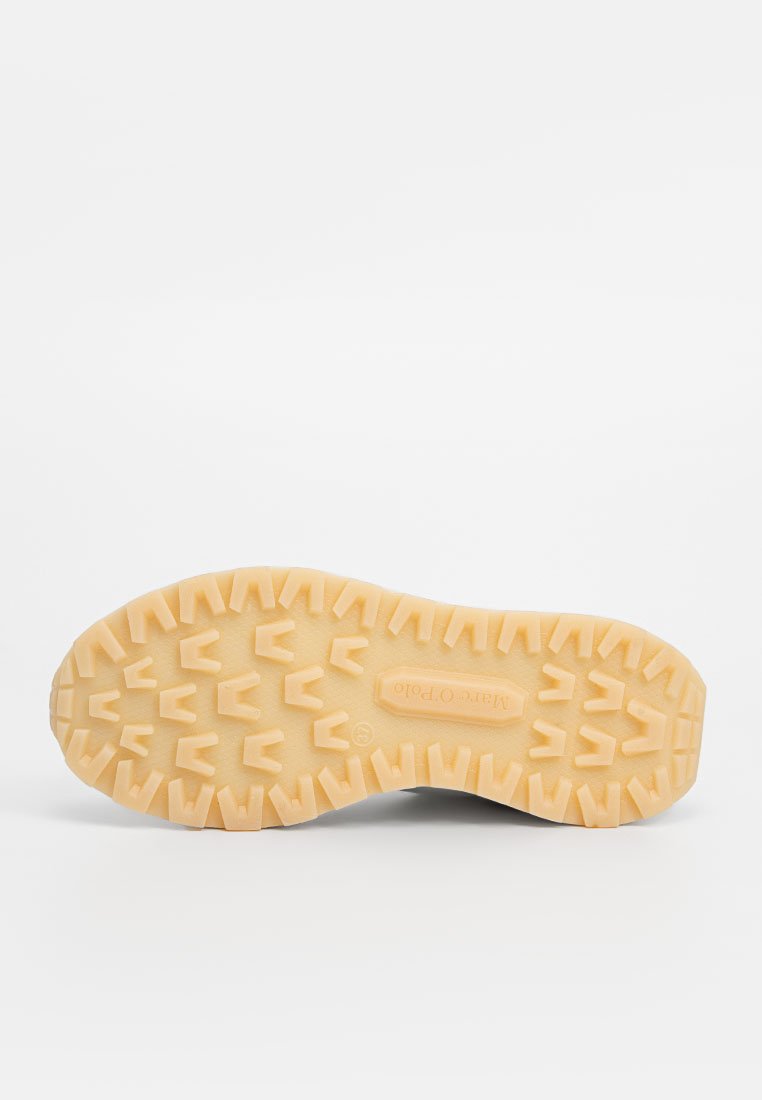 Semelle en caoutchouc de chaussure de randonnée avec une surface texturée et à motifs. Présente des nervures pour une meilleure adhérence. Couleur : beige clair.