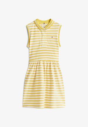 Rochie fără mâneci cu dungi galbene și albe, cu guler polo, cu patru nasturi și fustă adunată. Confecționată din material de bumbac.
