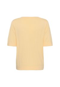Haut tricoté jaune clair à manches courtes avec un large col rond et un ourlet droit, vu de dos sur un fond uni.