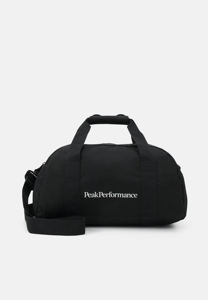 Bolsa de viaje negra hecha de tela resistente, con dos asas robustas, una correa de hombro desmontable y un logotipo blanco en la parte frontal.