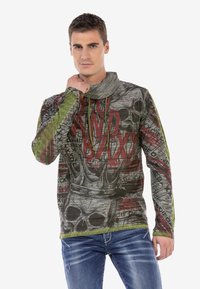 Langärmliges Grafikshirt in Grau mit schwarzen und roten Schädels- und Kronendesigns, ausgestattet mit grünen und schwarzen strukturierten Ärmel und einem Stehkragen.