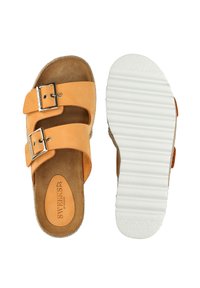Tan leather sandals with two adjustable straps and silver buckles, featuring a soft, textured footbed and a white, ridged rubber sole.