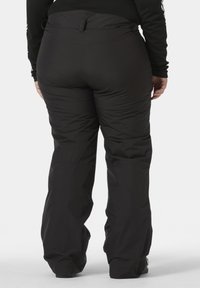 Zwarte geïsoleerde broek met een gladde afwerking, een elastische tailleband en ritszakken. Het ontwerp is losjes passend en geschikt voor koud weer.