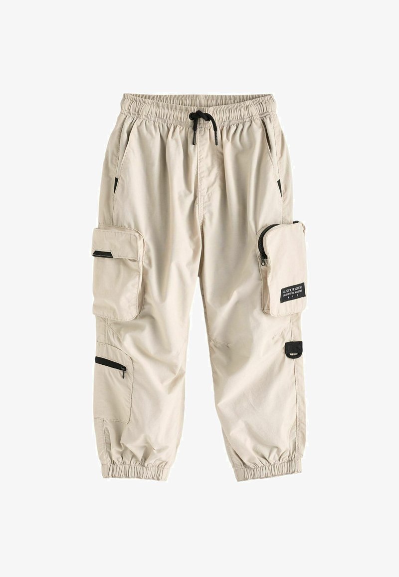 Beiga cargobyxor med elastisk midja, flera fickor, inklusive en ficka med dragkedja på sidan, och gummiband vid anklarna.