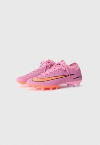 Pink soccer cleats with a smooth synthetic upper, black Nike logo, and bright orange accent. Features a textured sole with molded studs.
