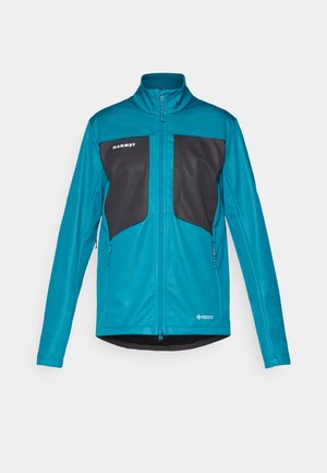 Teal mjukskaljacka med svarta accentpaneler. Har en hög krage, framdragkedja och två sidofickor. Lättviktsmaterial med slät textur.