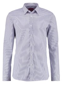 Randig skjorta i blått och vitt. Har en klassisk krage, långa ärmar och vita knappar. Tillverkad av lättviktsmaterial.