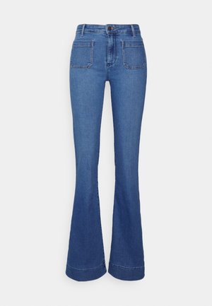 Jeans in denim blu a zampa con vita media, dotati di due tasche anteriori e due tasche posteriori. Tessuto morbido con una finitura leggermente sbiadita.