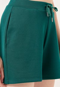 Groene katoenen shorts van een katoenmix met een trekkoord in de tailleband, zijzakken en een gladde textuur, met een rechte snit en gestikte zoom.