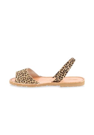 Flat sandal with leopard print straps, open toe, slingback design, and a tan sole, shown from the side on a white background.