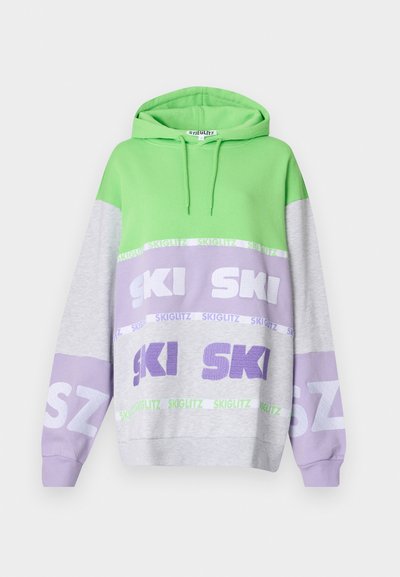 Color-blocked hoodie featuring green, gray, and lavender panels. Displays "SKI" in bold text and has a drawstring hood. Soft cotton material.