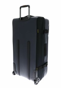 Valise bleu marine à coque rigide, avec deux roues à roulement fluide, une poignée de transport et des sangles de compression ajustables sur le côté.