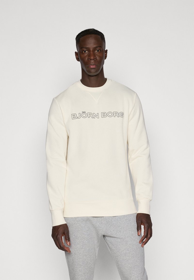 Cremfarbener Sweatshirt mit Rundhalsausschnitt und gerippten Bündchen, mit demtext "BJÖRN BORG" in fetten schwarzen Buchstaben über der Brust.