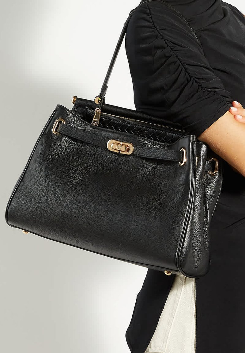 Black leather handbag with a structured design, gold hardware accents, and a woven interior. Features a top handle and zip closure.