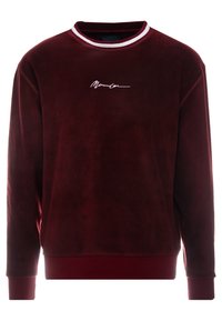 Bordeaux velours sweatshirt med rund halsudskæring, der har hvidt og rødt ribbet trim samt broderet signaturdetalje på forsiden.