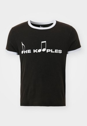 Black cotton T-shirt with white musical note graphic and "THE KOOPLES" text. Features contrast white trim on the sleeves and neckline.