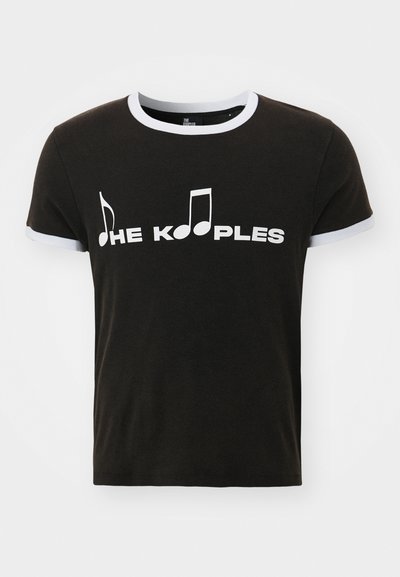 Crna pamučna majica s bijelom grafikom glazbene note i natpisom "THE KOOPLES". Ima kontrastne bijele obloge na rukavima i izrezu.