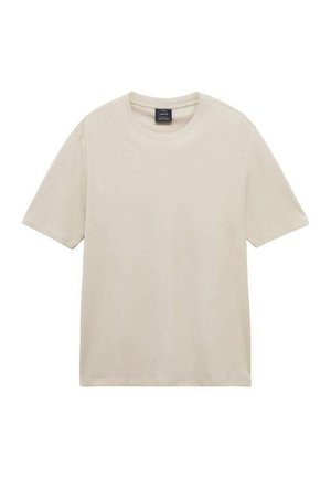 Tricou scurt cu mânecă scurtă, de culoare bej deschis, realizat din bumbac moale. Prezintă un gât clasic și o croială confortabilă, cu un design minim și fără modele.