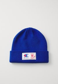 Sinine kudumine beanie, mille allääres on volditud cuff, esiküljel on silmapaistvalt valge ja punane logo silt "Champion" ja "92".