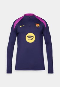 Purple and navy long-sleeve jersey with a zip collar, featuring a yellow Spotify logo and Barcelona emblem on the chest. Nike branding also present.